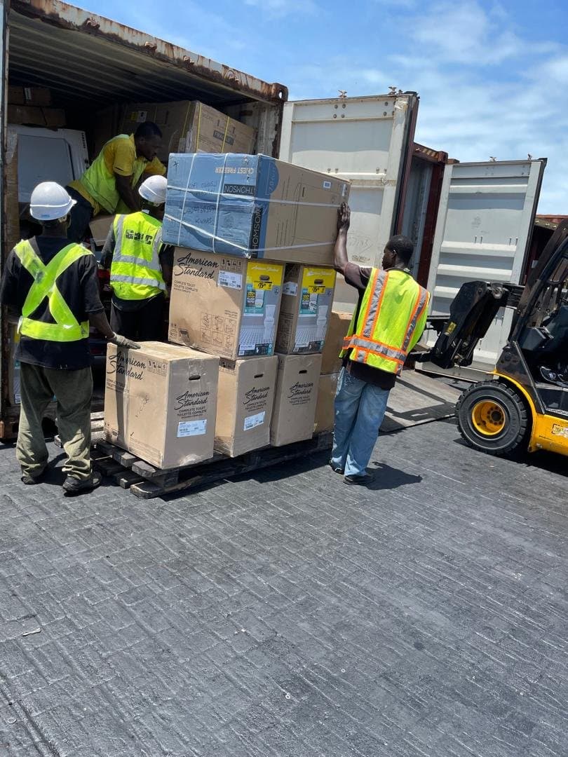 Workers unloading a shipping container at the port
