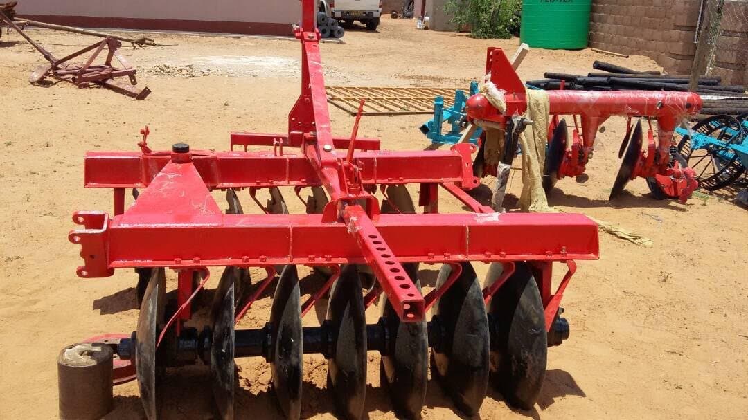 Disc harrow set down in a sandy storage yard