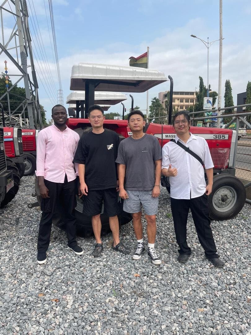 Laluna Enterprise with international partners alongside a Massey Ferguson tractor