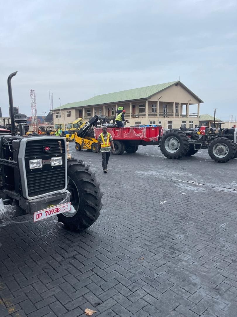 Tractor and trailer being handled at the port with a forklift