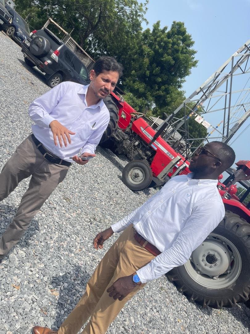 Laluna Enterprise team discussing tractors in the supply yard
