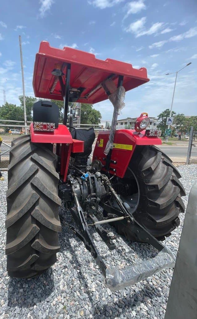 Rear view of a Massey Ferguson 385 tractor with a tipping trailer attachment